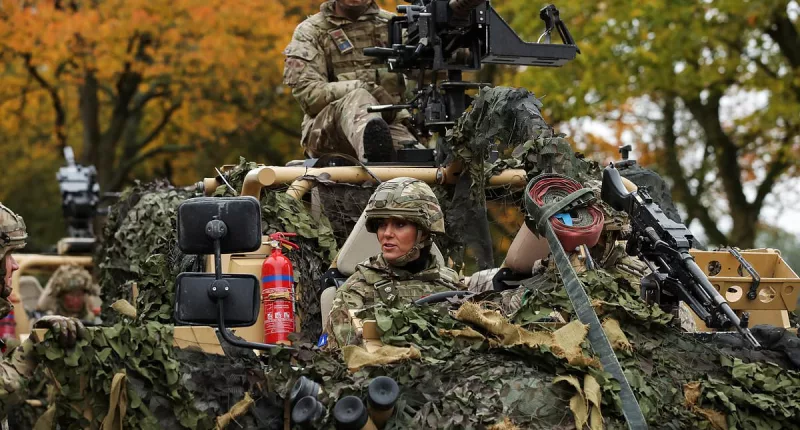 Kate dons camouflage gear to drive a vehicle around Norfolk barracks