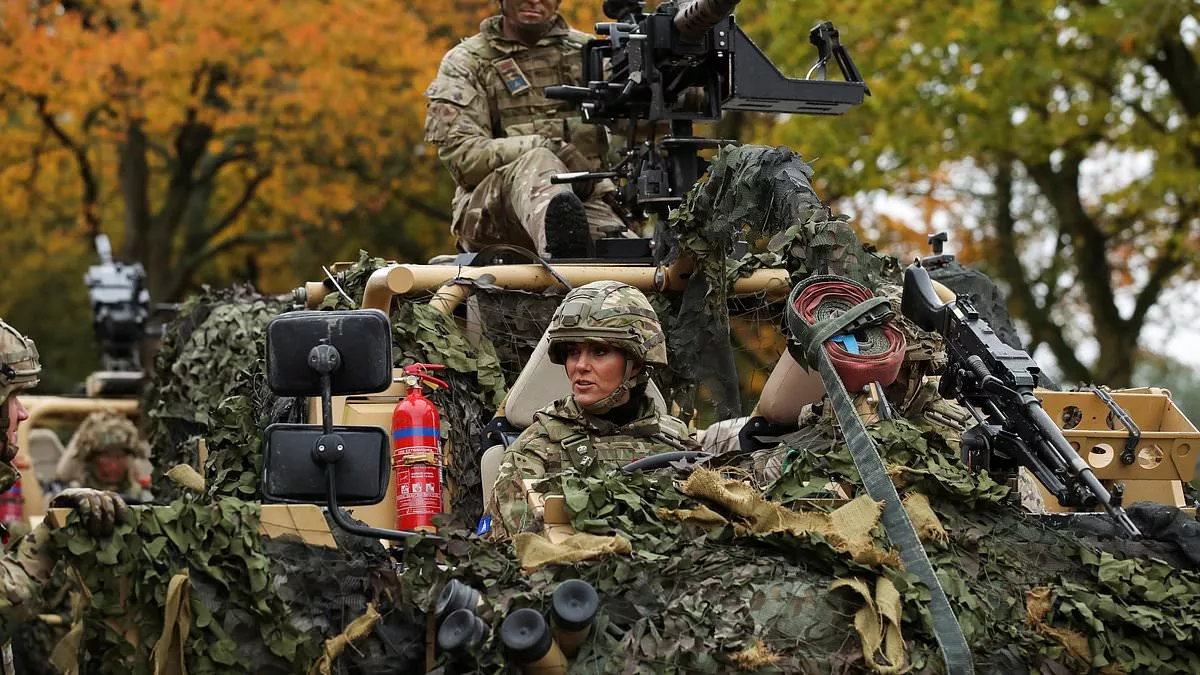 Kate dons camouflage gear to drive a vehicle around Norfolk barracks