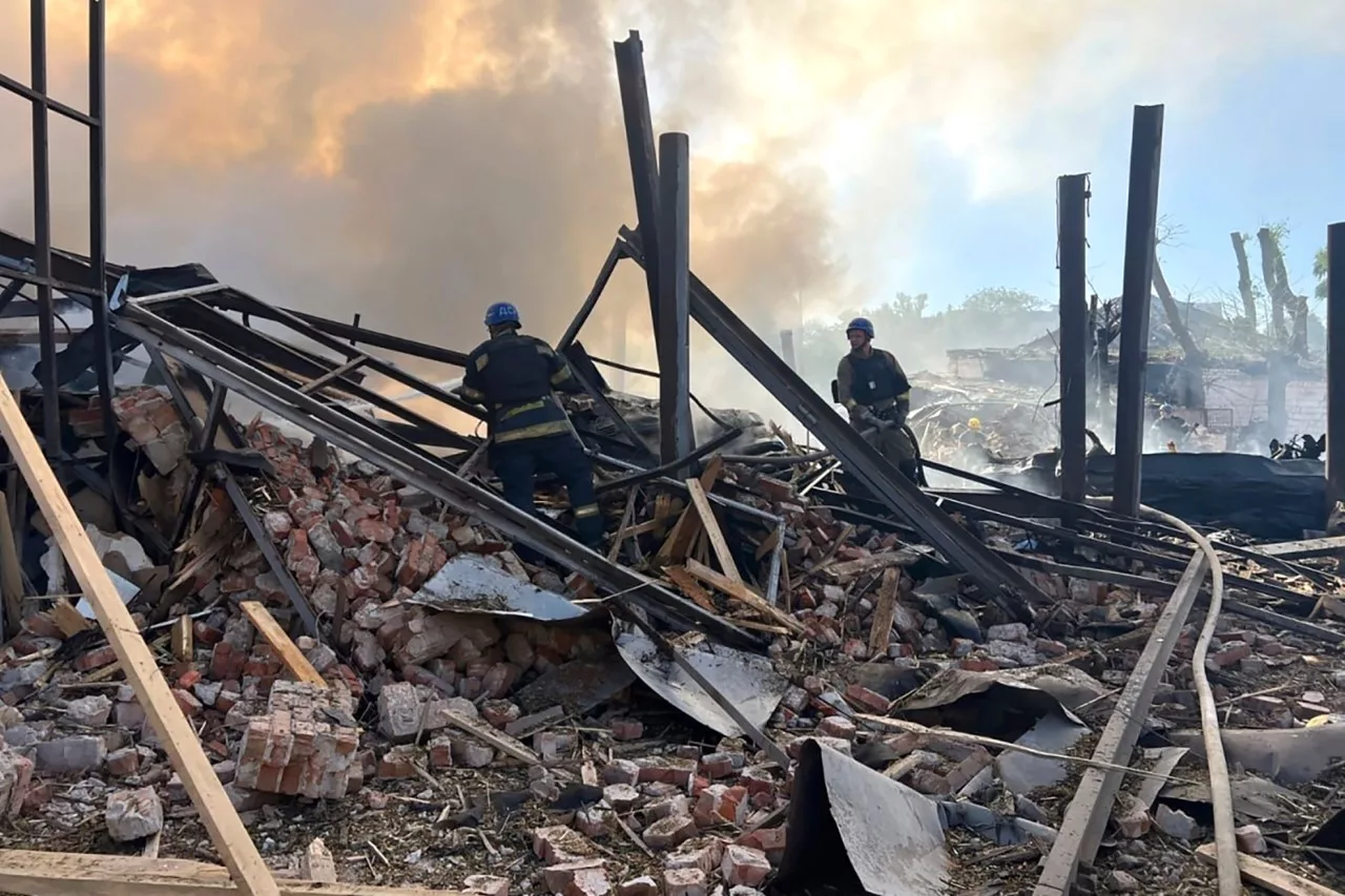 In this photo provided by the Ukrainian Emergency Service, emergency services personnel work to extinguish a fire following a Russian attack in Kryvyi Rih, Ukraine, Friday, Sept. 8, 2023. (Ukrainian Emergency Service via AP)