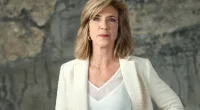 Kelly Siegler poses in a white suit