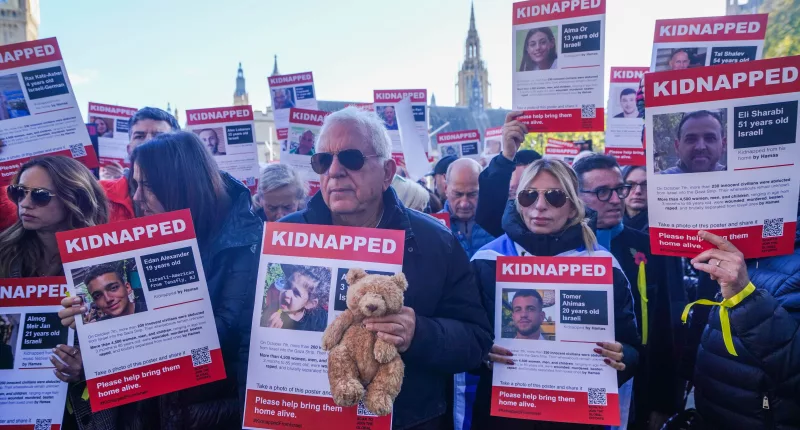 Protesters held a vigil demanding the release of 240 hostages kidnapped by Hamas raiders, carrying pictures of kidnapped men, women, and children