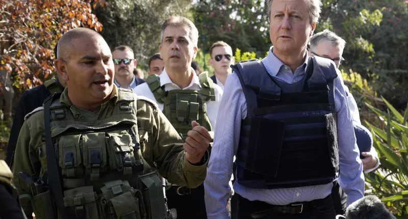 Lord Cameron, pictured with Eli Cohen, visits Kibbutz Be'eri where Hamas terrorists massacred Israeli civilians