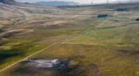 In this image provided by the U.S. Air Force, wind turbines spin near the Malmstrom Air Force Base missile launch site Alpha-03 in Geyser, Mont., in August 2023. As the nation