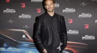 Paul Walker posing in a suit at the Europe premiere of