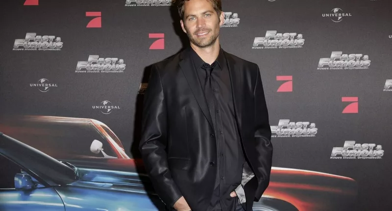Paul Walker posing in a suit at the Europe premiere of