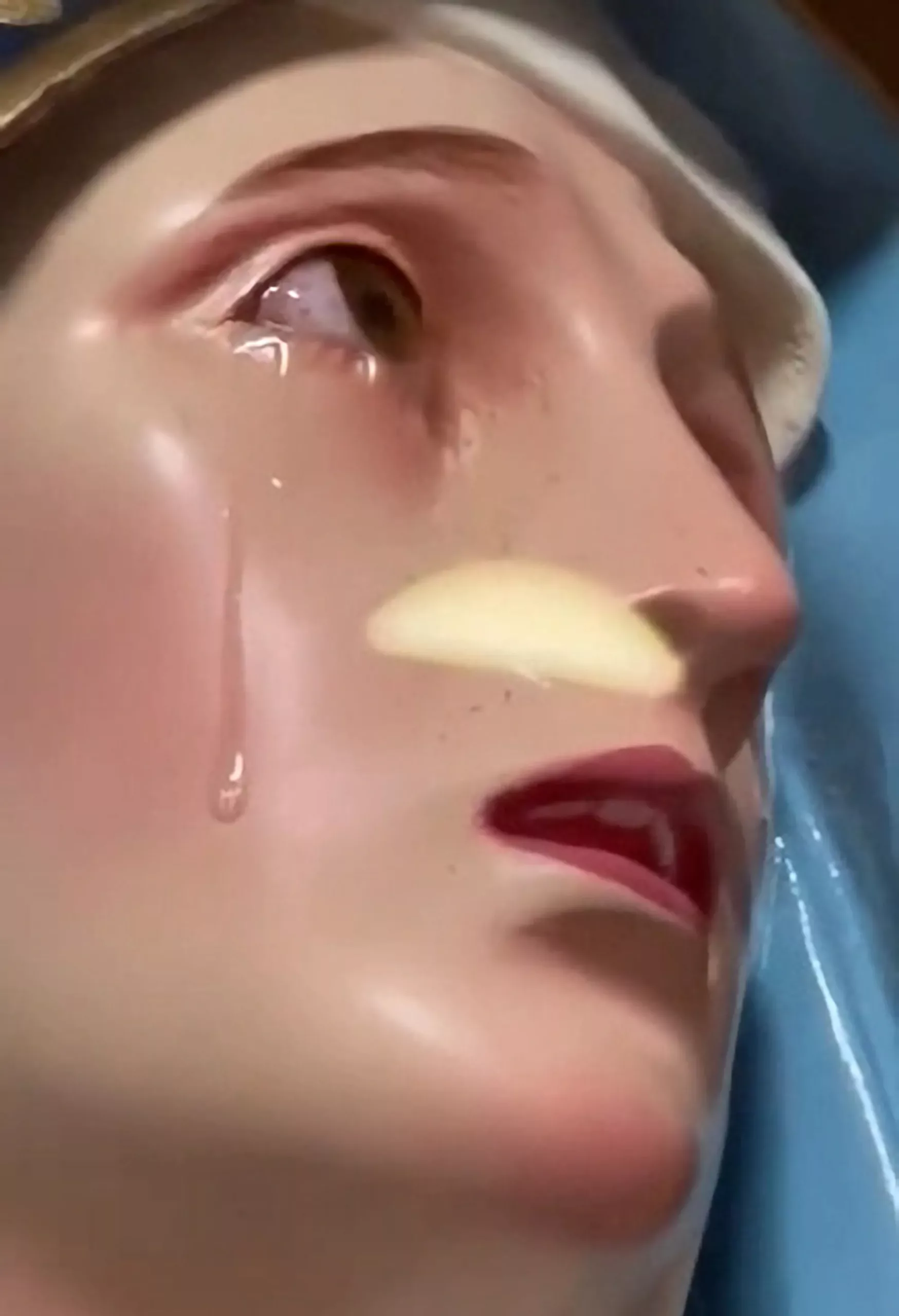 Videos show the statue seemingly shedding tears