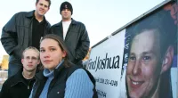 Friends of Joshua Guimond stand by a find joshua sign