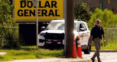 FILE - Law enforcement officials continue their investigation at a Dollar General Store that was the scene of a mass shooting, Aug. 27, 2023, in Jacksonville, Fla. Family members of three Black people who were fatally shot this summer inside the Dollar General store by a shooter who had posted racist writings sued the store