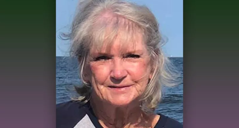 Claudia Voight smiles with a body of water behind her.