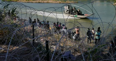 FILE - Migrants who crossed into the U.S. from Mexico are met with concertina wire along the Rio Grande, Sept. 21, 2023, in Eagle Pass, Texas. Texas moved closer Thursday, Oct. 26, to giving police broad new authority to arrest migrants who cross the U.S.-Mexico border, putting Republican Gov. Greg Abbott closer to a new confrontation with the Biden administrations over immigration. (AP Photo/Eric Gay, File)