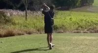 Don't look behind you! Golfer shows nerves on steel from the tee as two male pythons fight for the right to mate just metres away