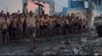 The moment a man hands over his assault rifle during what Israel claims is a mass surrender of Hamas operatives