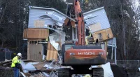The house of murdered University of Idaho students is demolished by a bulldozer.