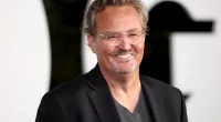 Smiling Photo of Mathew Perry wearing a black blazer