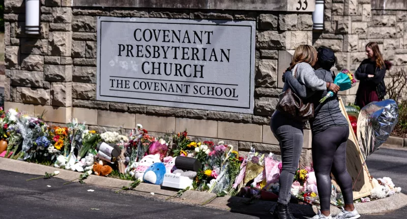 FILE - Two women hug near a memorial at the entrance to The Covenant School, March 29, 2023, in Nashville, Tenn. Nashville Police have “exhausted all available investigative avenues” in the hunt for the person who leaked pages from a school shooter’s journals to a conservative commentator, the department announced in an email sent to media late on Friday, Dec. 8, 2023. (AP Photo/Wade Payne, File)
