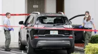 FILE -Forensic technicians work on the vehicle authorities say officers fired shots at, that breached security at President Donald Trump
