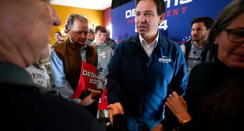 FILE - Republican presidential candidate Florida Gov. Ron DeSantis talks with audience members during a meet and greet, Friday, Nov. 3, 2023, in Denison, Iowa. Former President Donald Trump was the first choice of 51% of likely Iowa caucus participants in a Des Moines Register-NBC News-Mediacom Iowa Poll published Monday, Dec. 11. Florida Gov. Ron DeSantis, who has vowed that he will win Iowa, had the support of 19%. (AP Photo/Charlie Neibergall, File)