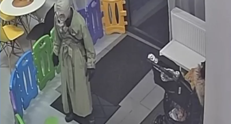 This is the terrifying moment a mystery figure wearing a gas mask walked into a kids play centre