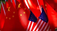 FILE - The flags of the U.S. and Chinese are displayed together on top of a trishaw in Beijing on Sept. 16, 2018. Lawmakers intent on reducing China’s influence on the U.S. economy are looking to broaden the effort internationally by requiring the U.S. Treasury to form a plan that reduces Beijing’s role at the Inter-American Development Bank. (AP Photo/Andy Wong, File)