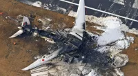 The charred wreckage of the Japan Airlines plane at Haneda airport
