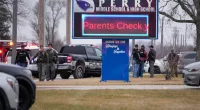 Perry High School principal shot distracting gunman, daughter says