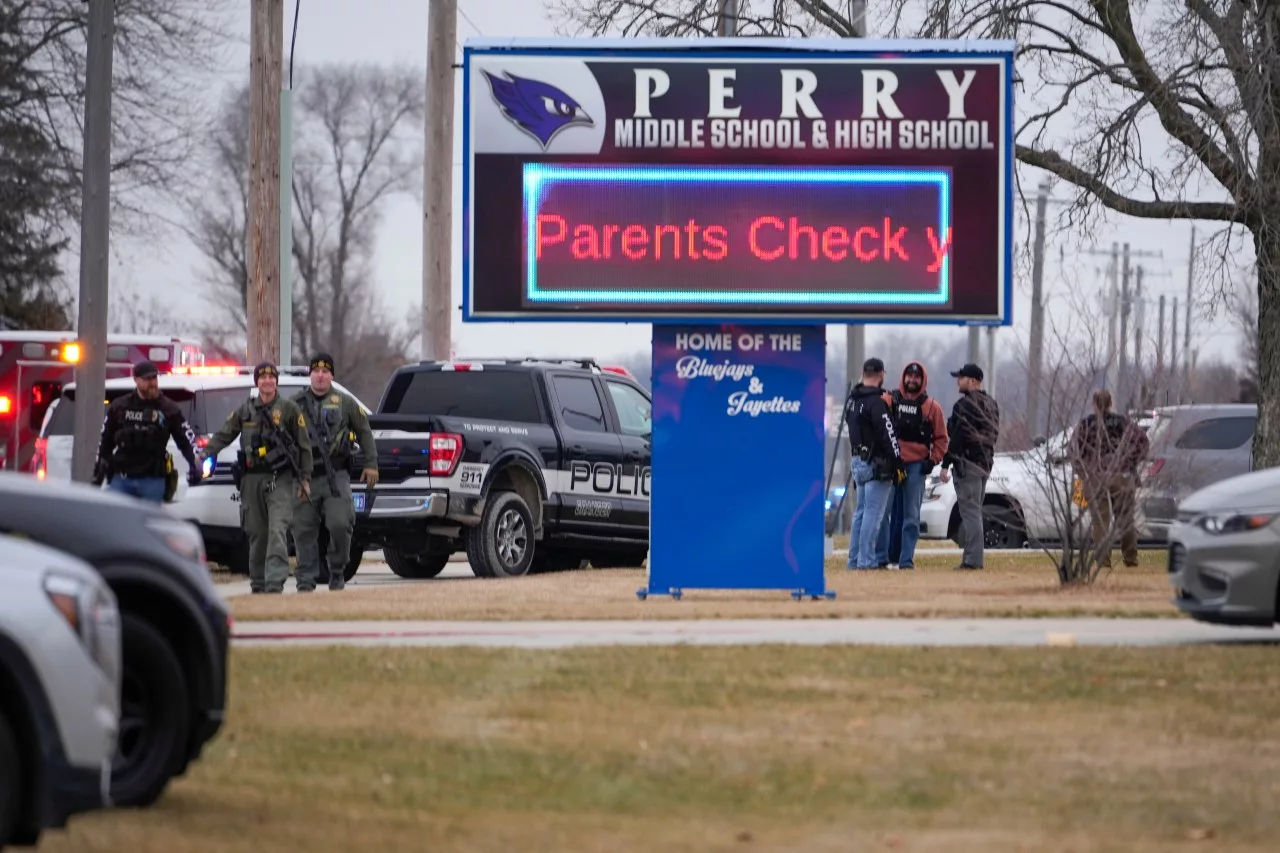 Perry High School principal shot distracting gunman, daughter says