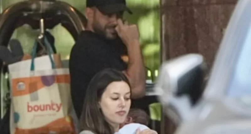 Adrian Portelli is seen with girlfriend Karlie Butler and newborn son