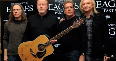 FILE - Members of The Eagles, from left, Timothy B. Schmit, Don Henley, Glenn Frey and Joe Walsh pose with an autographed guitar after a news conference at the Sundance Film Festival, Jan. 19, 2013, in Park City, Utah. On Wednesday, Feb. 21, 2024, an unusual criminal trial is set to open over the handwritten lyrics to the band