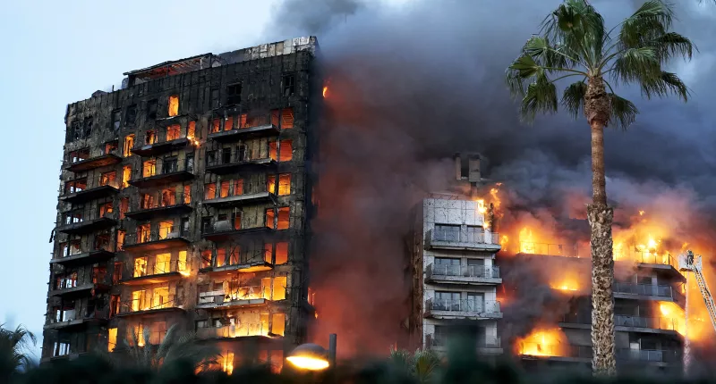 At least four are dead and 14 missing after the huge blaze engulfed to residential buildings in the Spanish city