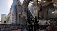 Firefighters work at the scene of a Russian missile strike that destroyed a train station in Kostiantynivka, Ukraine