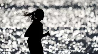FILE - A runner makes her way along the path at Gray