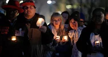People attend a candlelight vigil for victims of a shooting at a Kansas City Chiefs Super Bowl victory rally Thursday, Feb. 15, 2024 in Kansas City, Mo. More than 20 people were injured and one woman killed in the shooting near the end of Wednesday