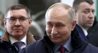 Vladimir Putin visits a plant in, Russia today and smiles to himself as he makes the rounds