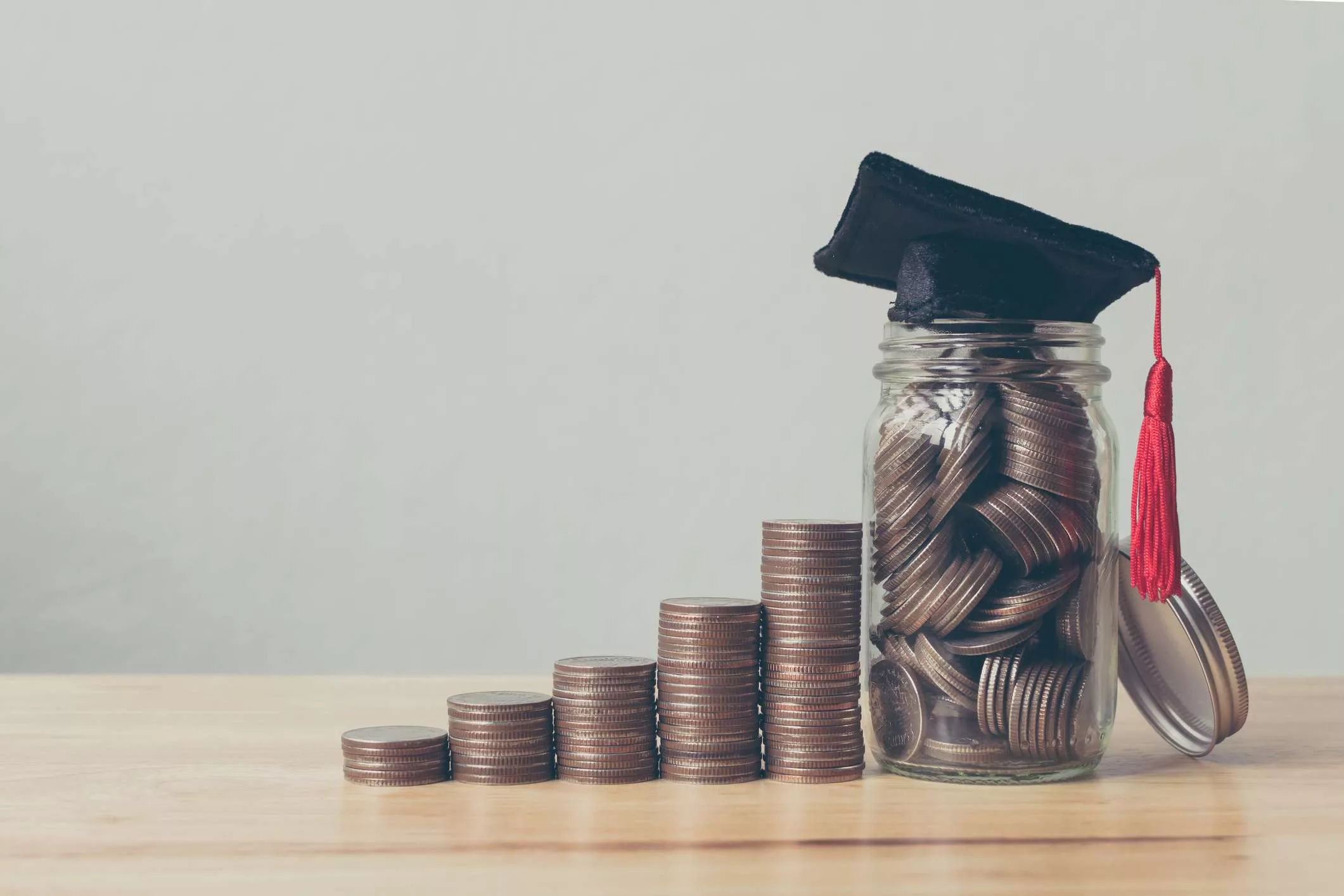 coins, jar filled with coins and a cap