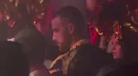 Travis Kelce glugs champagne around scantily-clad women in Las Vegas