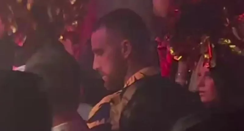 Travis Kelce glugs champagne around scantily-clad women in Las Vegas