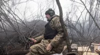 A Ukrainian soldier awaits orders as his country's battle against the invading troops of Vladimir Putin continues