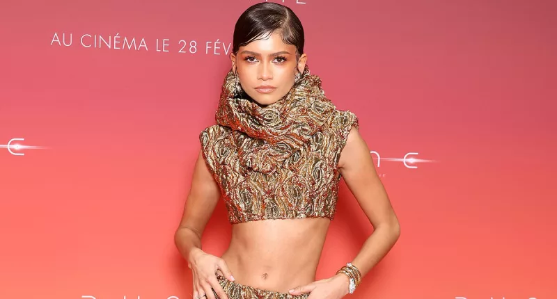 Zendaya flaunts her washboard abs in a glamorous gold crop top