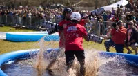 Contestants tested their strength in the weaponized pool noodle mud duel