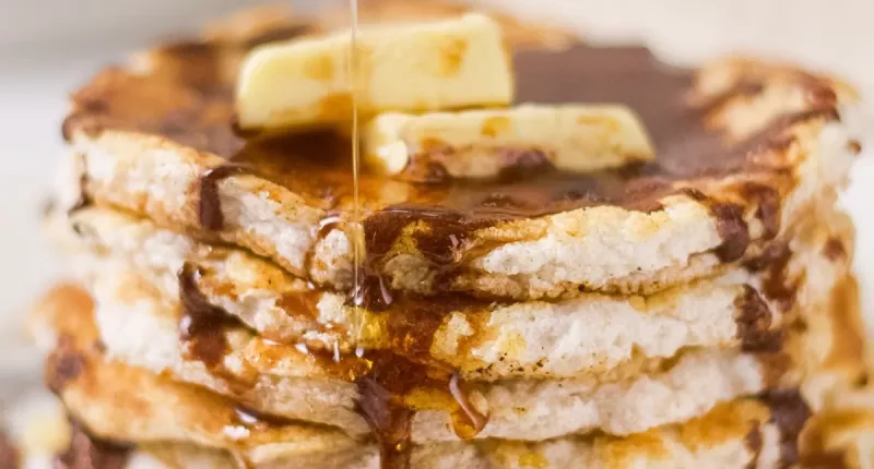 a stack of cinnamon cloud bread pancakes with syrup and butter