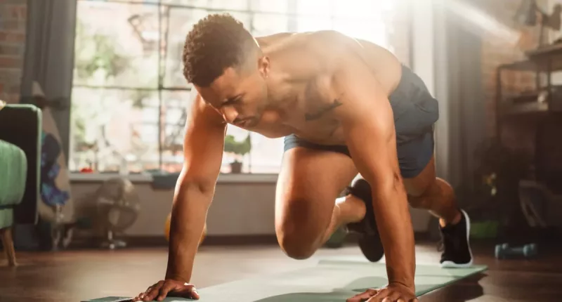 man doing mountain climbers exercise, concept of strength workouts for dad bod