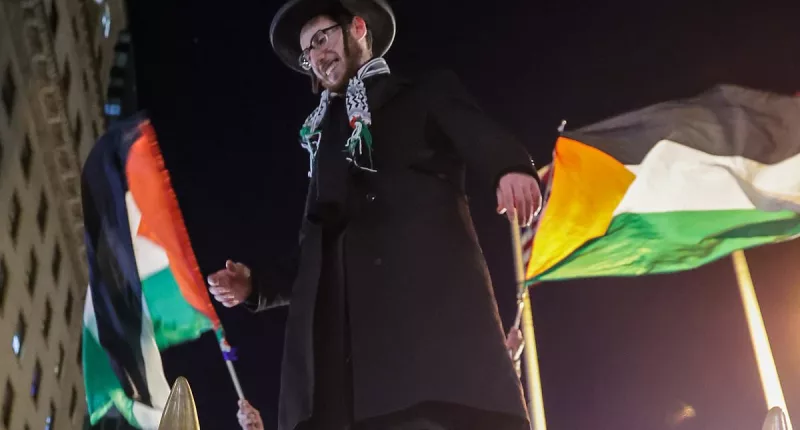 Pro-Palestine protesters mount Wall Street's Charging Bull