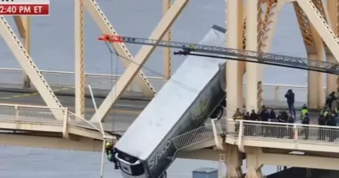 Race to save semi-truck driver stuck in vehicle as it hangs off BRIDGE