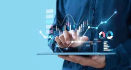 a holding a tablet with financial graphs