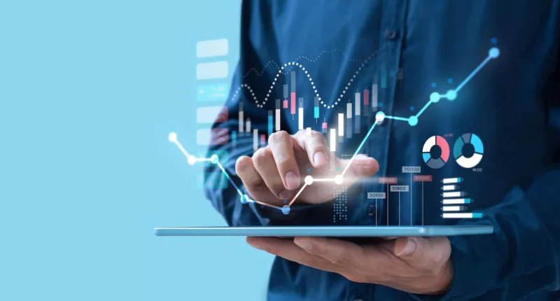 a holding a tablet with financial graphs