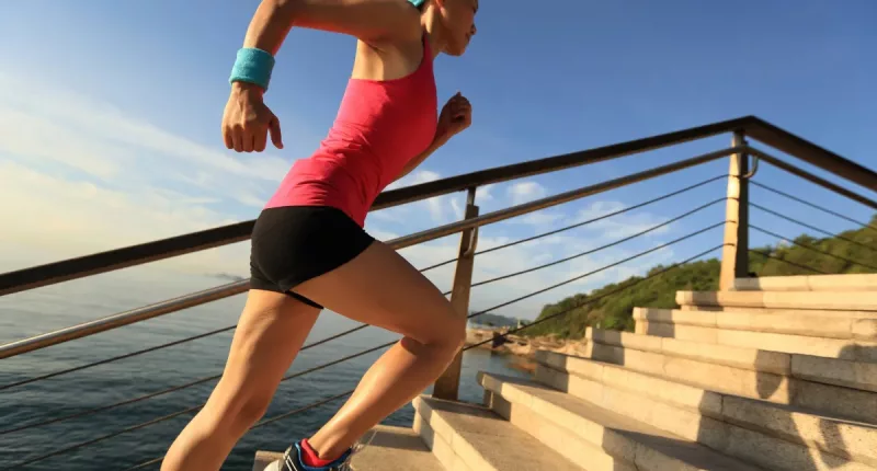 woman doing stair sprints outdoors, concept of high-intensity cardio exercises for weight loss