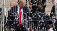 Trump waves at migrants through barbed wire fence at Mexican border