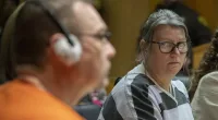 Jennifer Crumbley (right) looks at her husband James Crumbley (left) during their sentencing on four counts of involuntary manslaughter on Tuesday