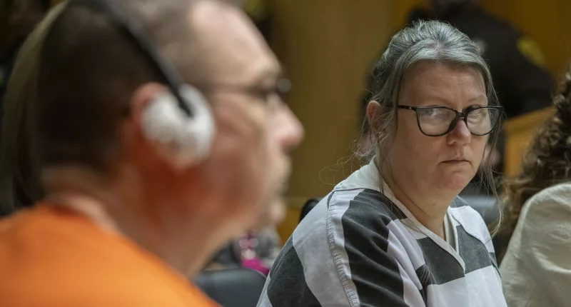 Jennifer Crumbley (right) looks at her husband James Crumbley (left) during their sentencing on four counts of involuntary manslaughter on Tuesday