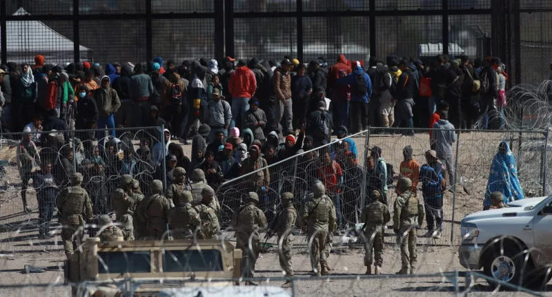 Migrants charged in border wall riot will stay in jail